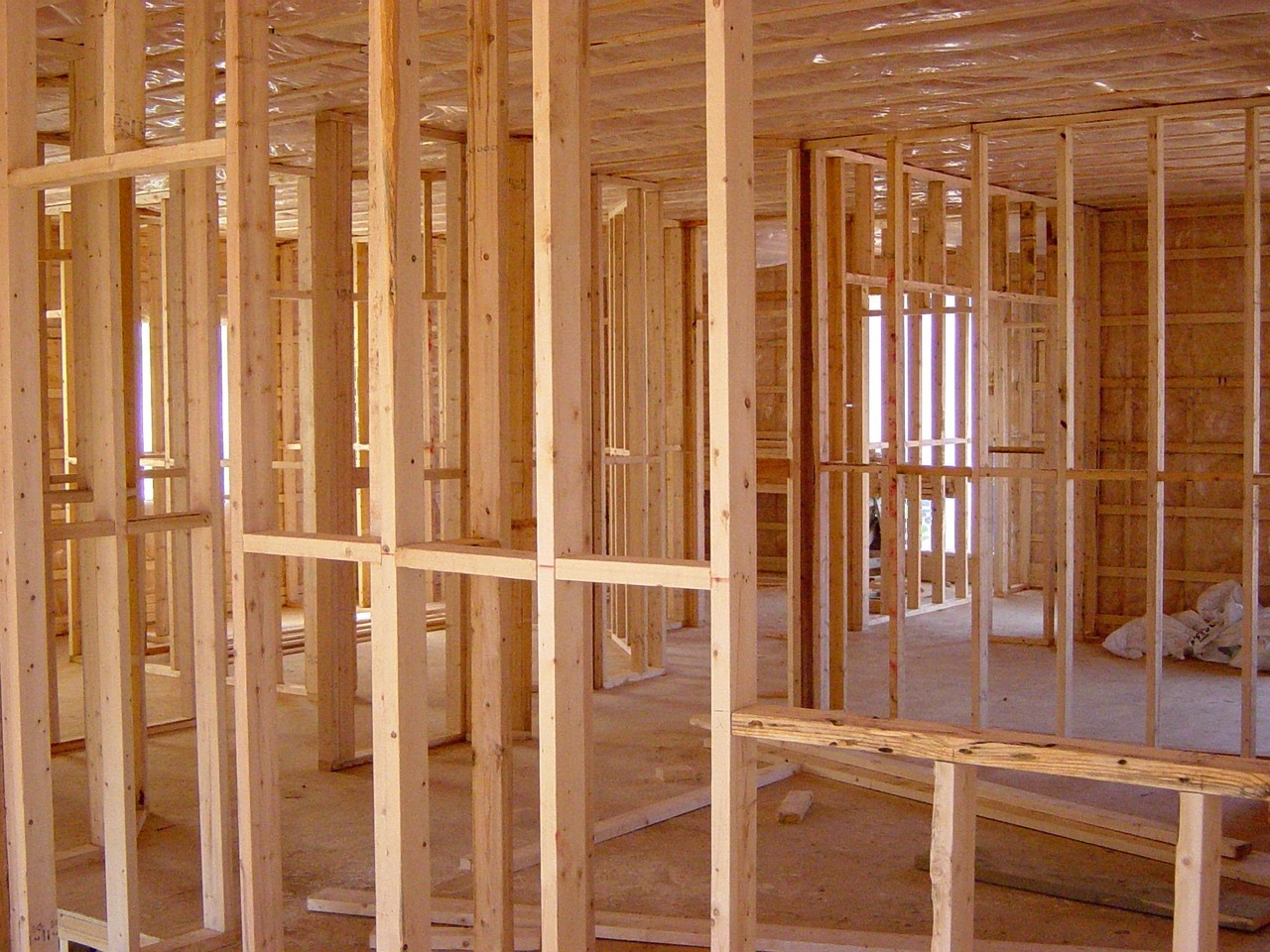 Dated construction photo log of custom home framing progress for owner review